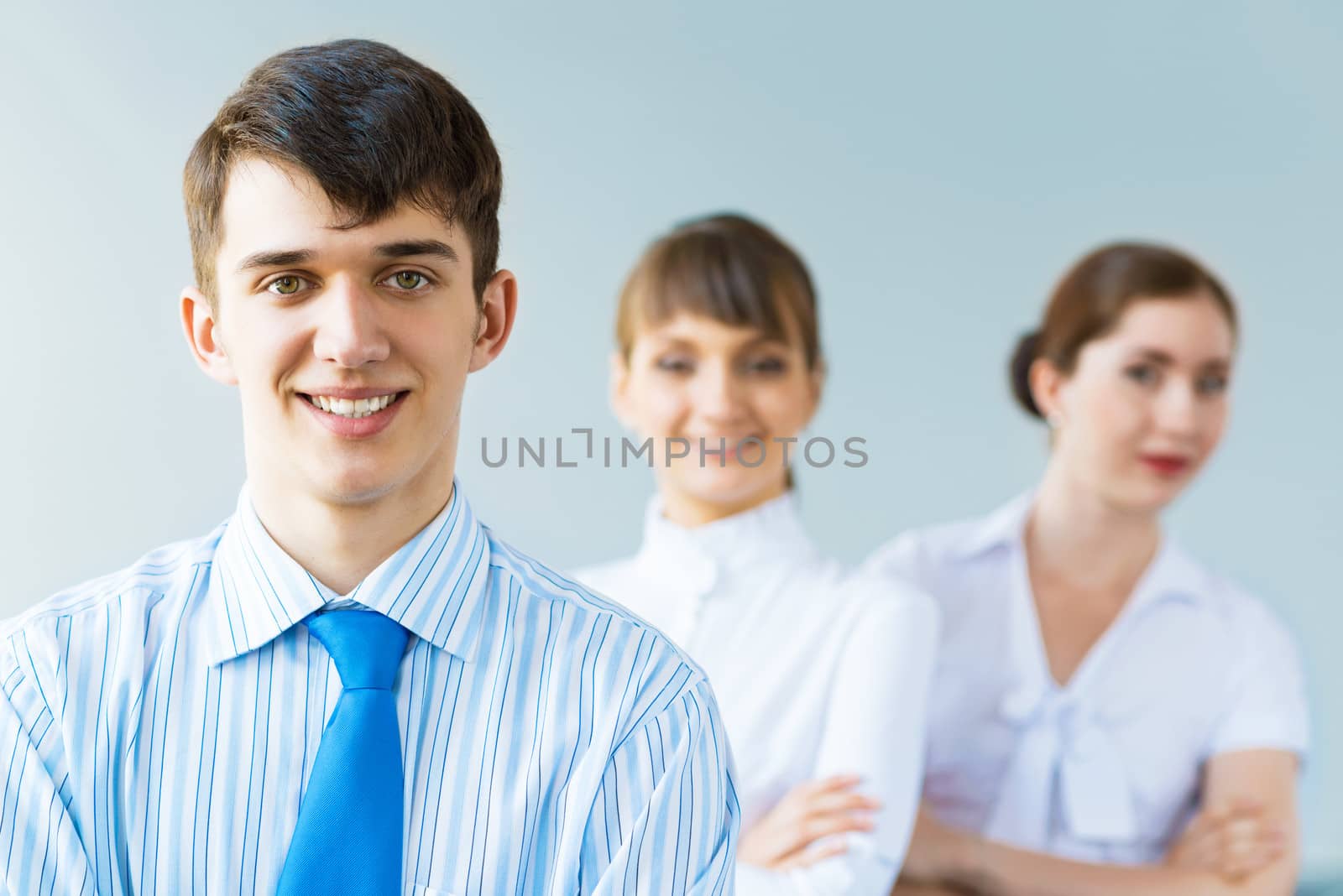 successful businessmen, a portrait of a businessman behind him are his colleagues