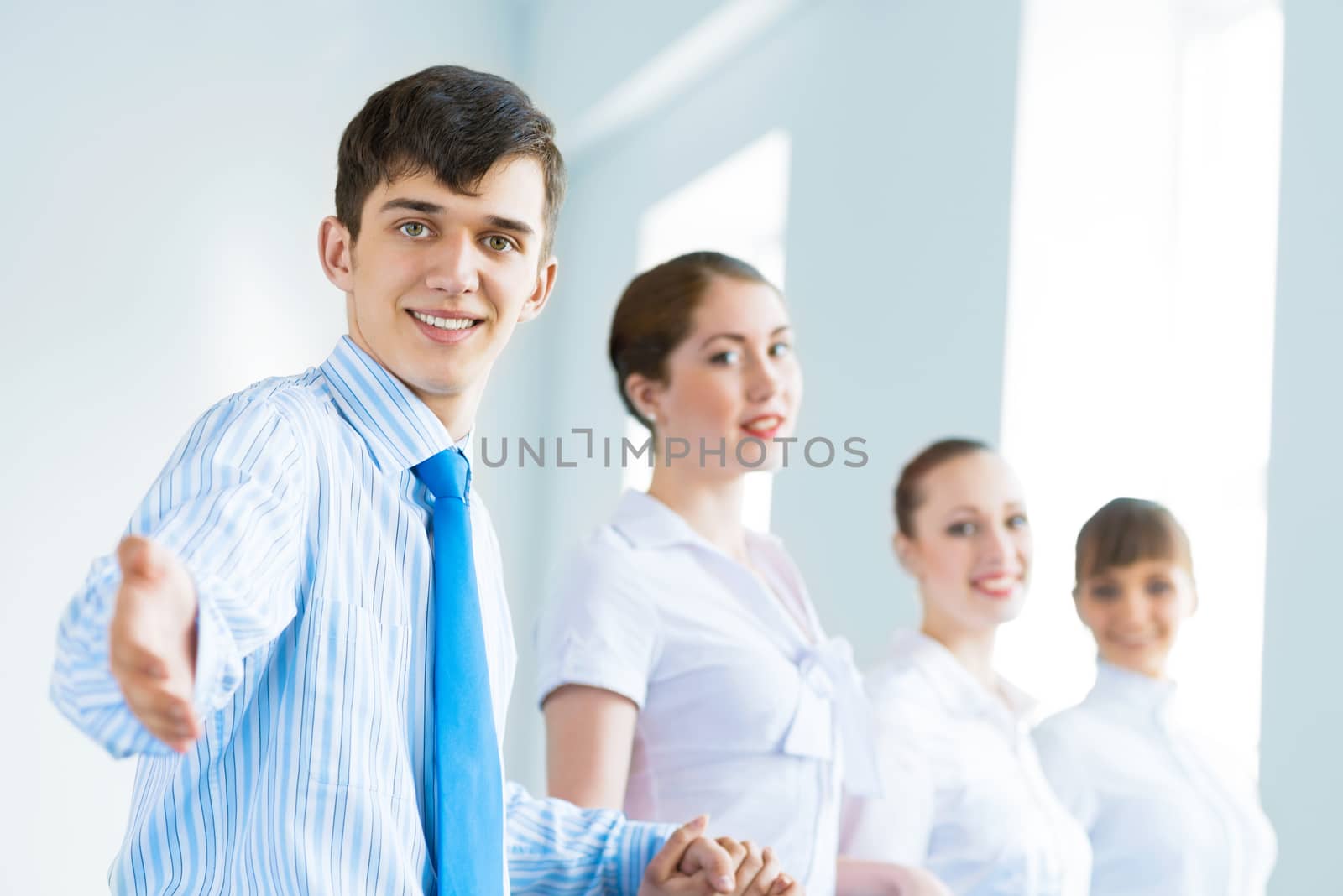 invitation to the team, the business man stretches out his hand, behind him a number of young businessmen