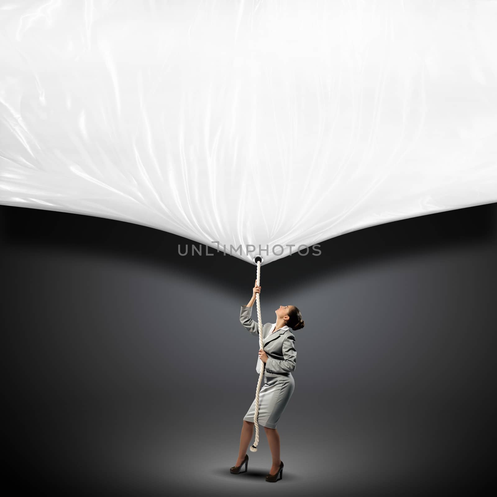 Image of businesswoman pulling blank banner. Place for text
