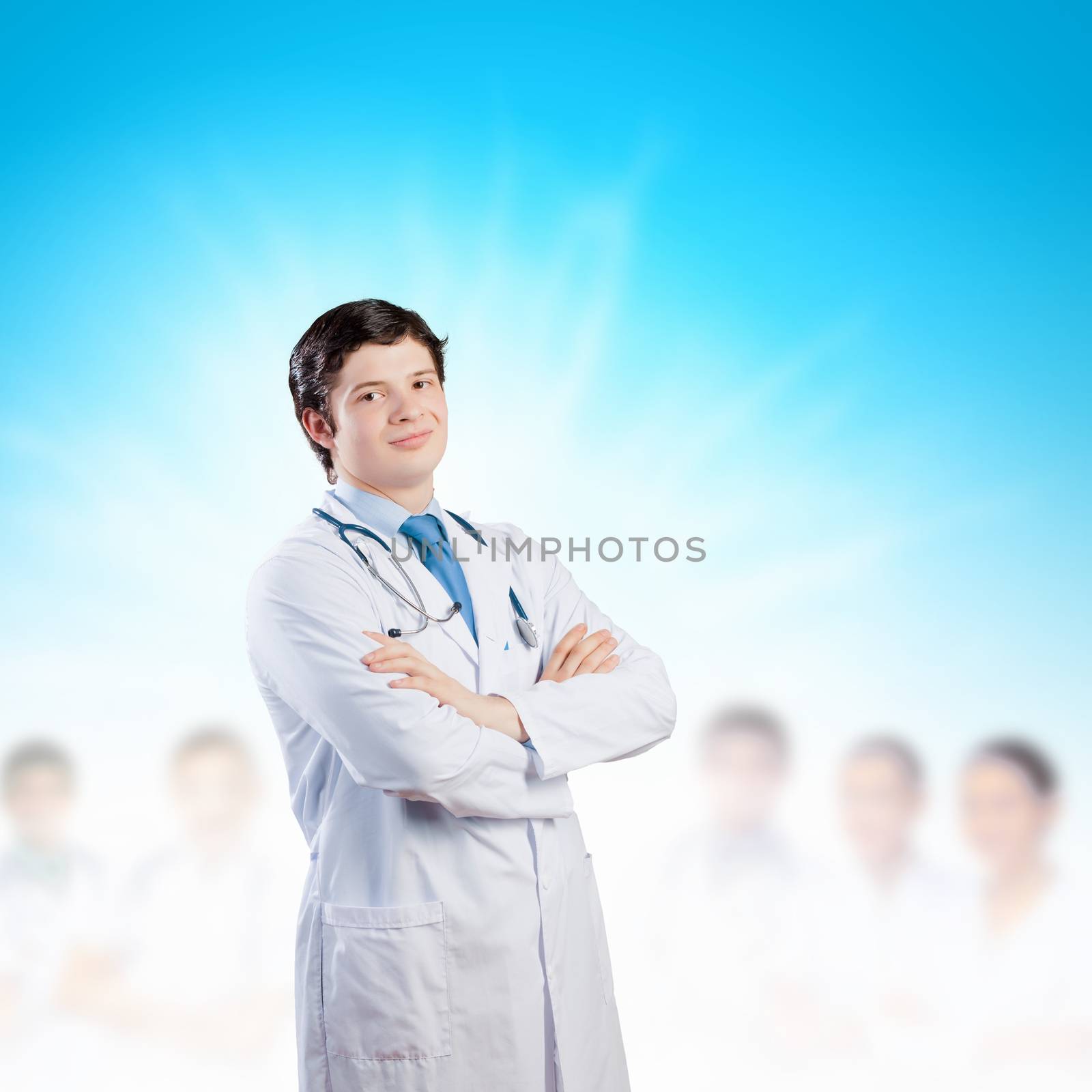 Image of happy confident doctor in uniform with colleagues at background