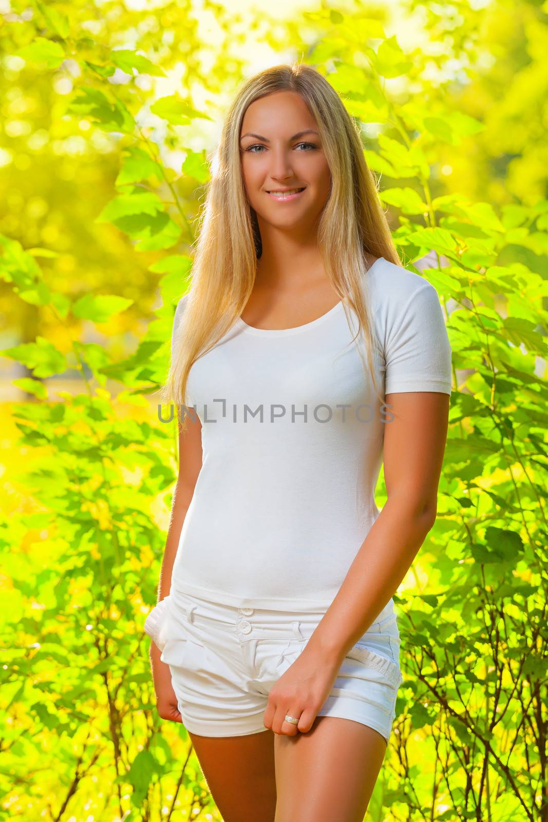 a beautiful blonde in a summer forest by mihalec