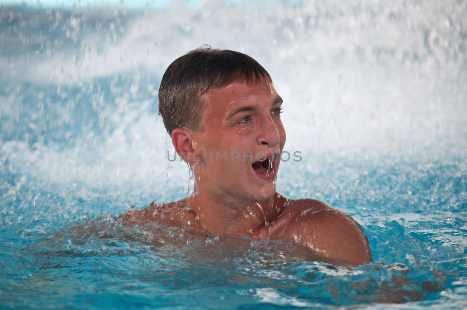 teen boy in blue swimming pool portrait  by LarisaP