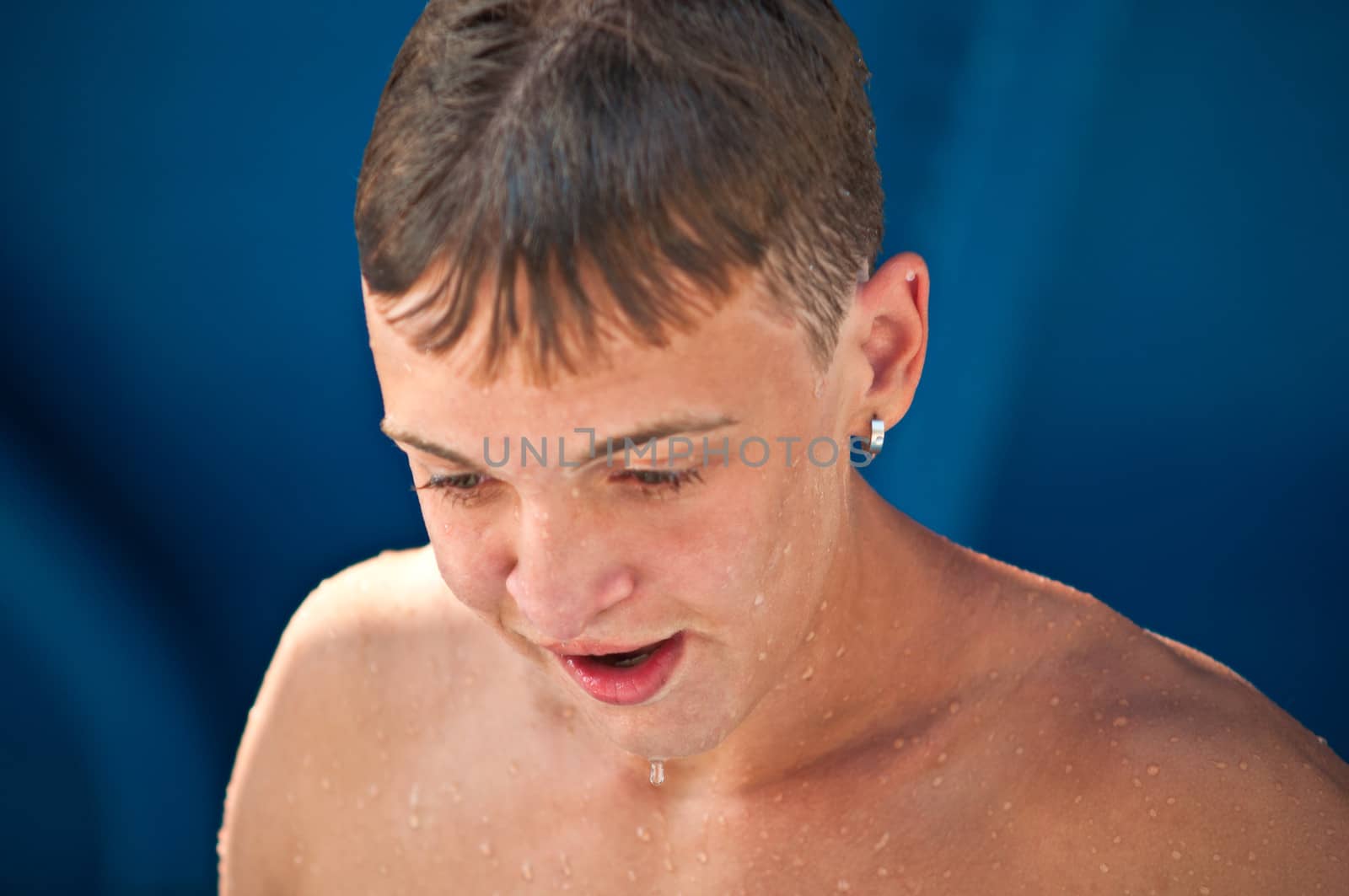 Portrait of a teenage boy wet after pool .