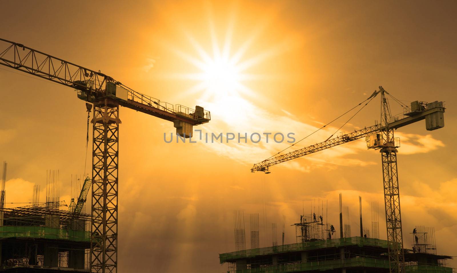 crane and building construction and sun set sky