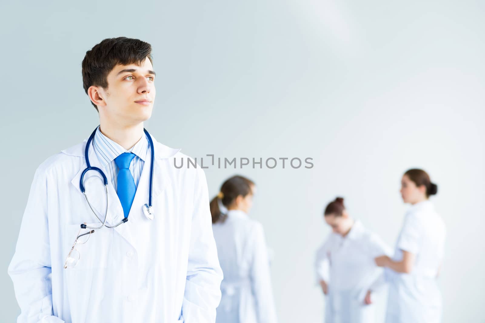 Portrait of a successful young doctor and hospital staff