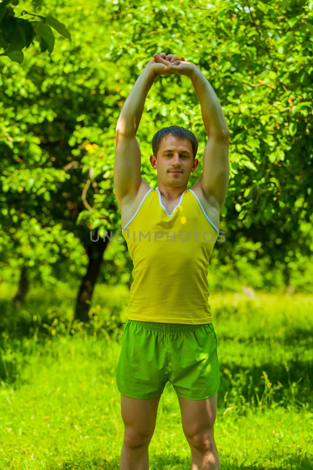 a young man do stretching muscles of arms