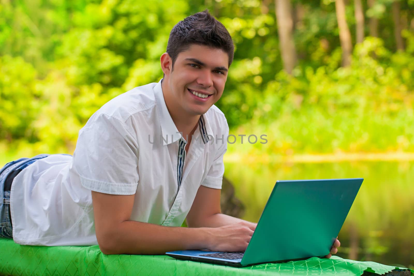 a young men lying with laptop