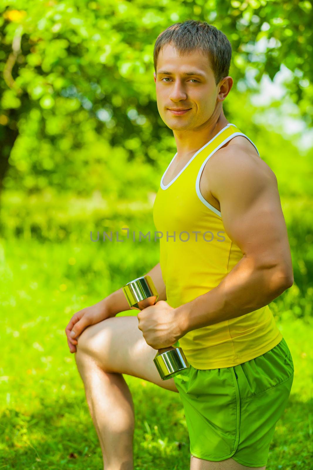 a young men with dumbbell by mihalec