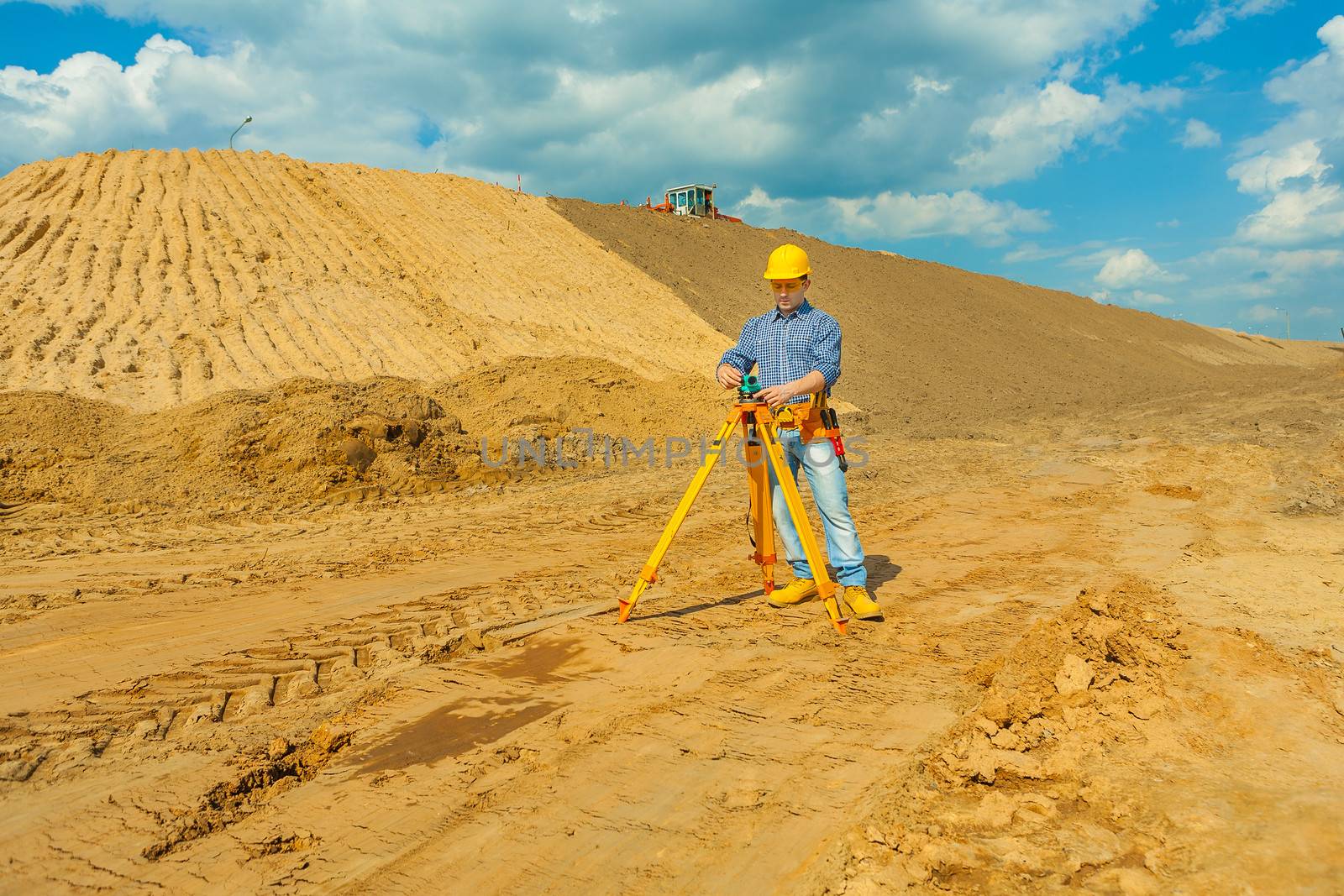 construction worker with theodolite