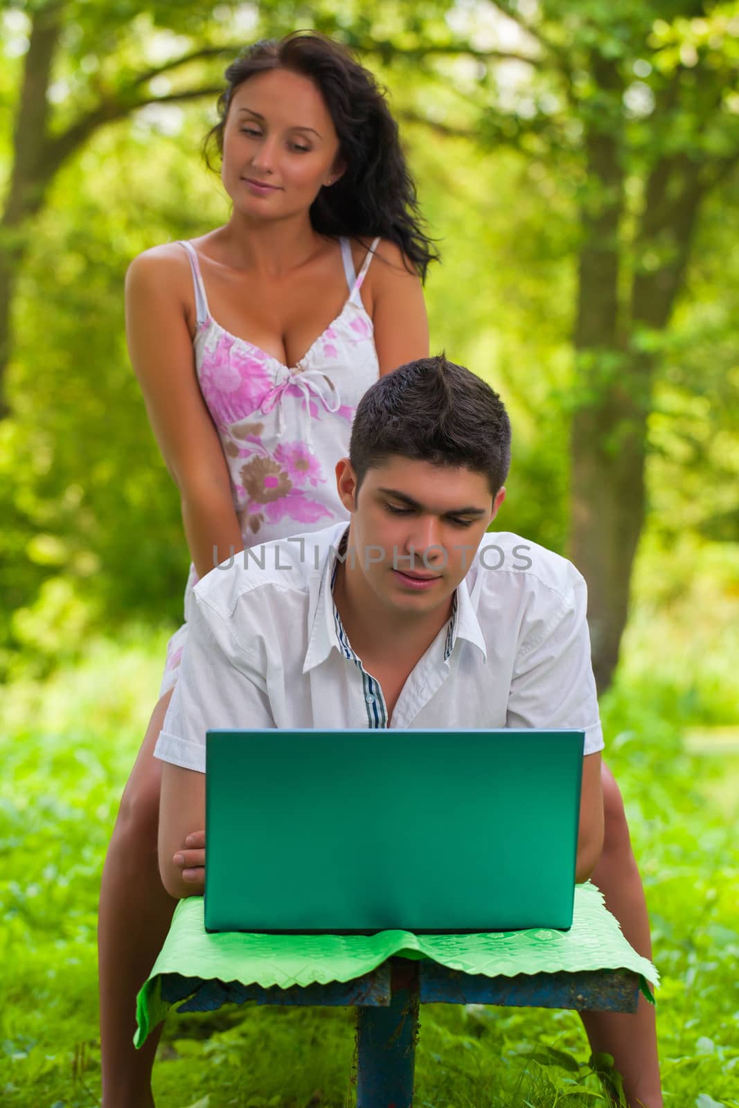 couple loking in laptop by mihalec