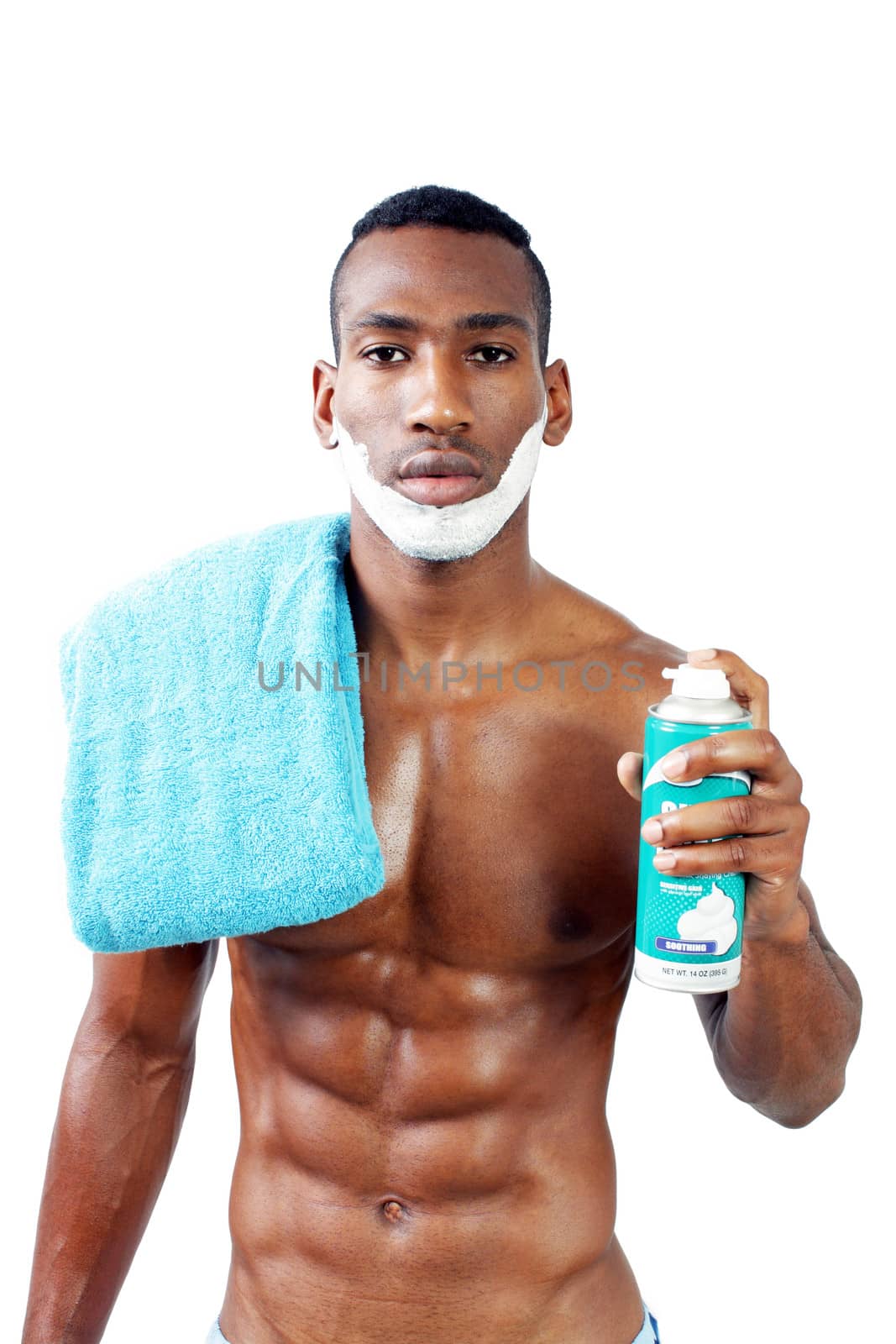 A handsome black man, holding a can of shaving cream, with shaving cream applied to his face.