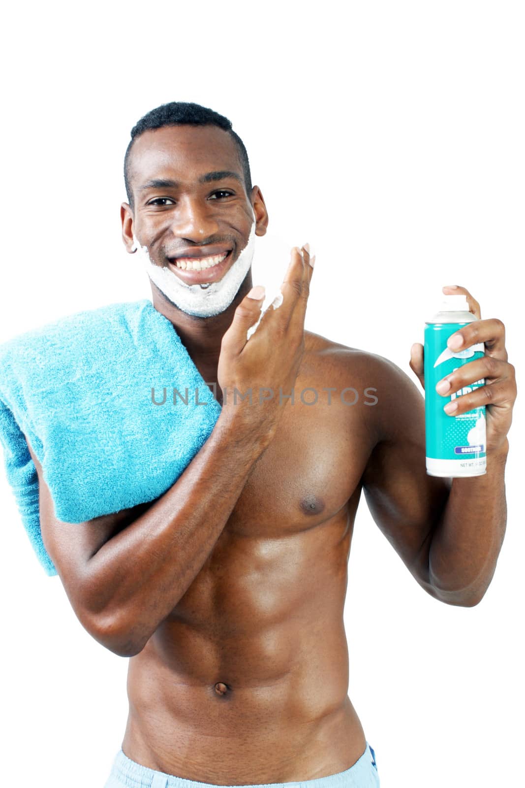 A handsome black man, holding a can of shaving cream, with shaving cream applied to his face.