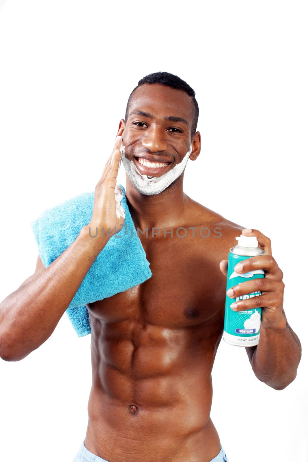 A handsome black man, holding a can of shaving cream, with shaving cream applied to his face.