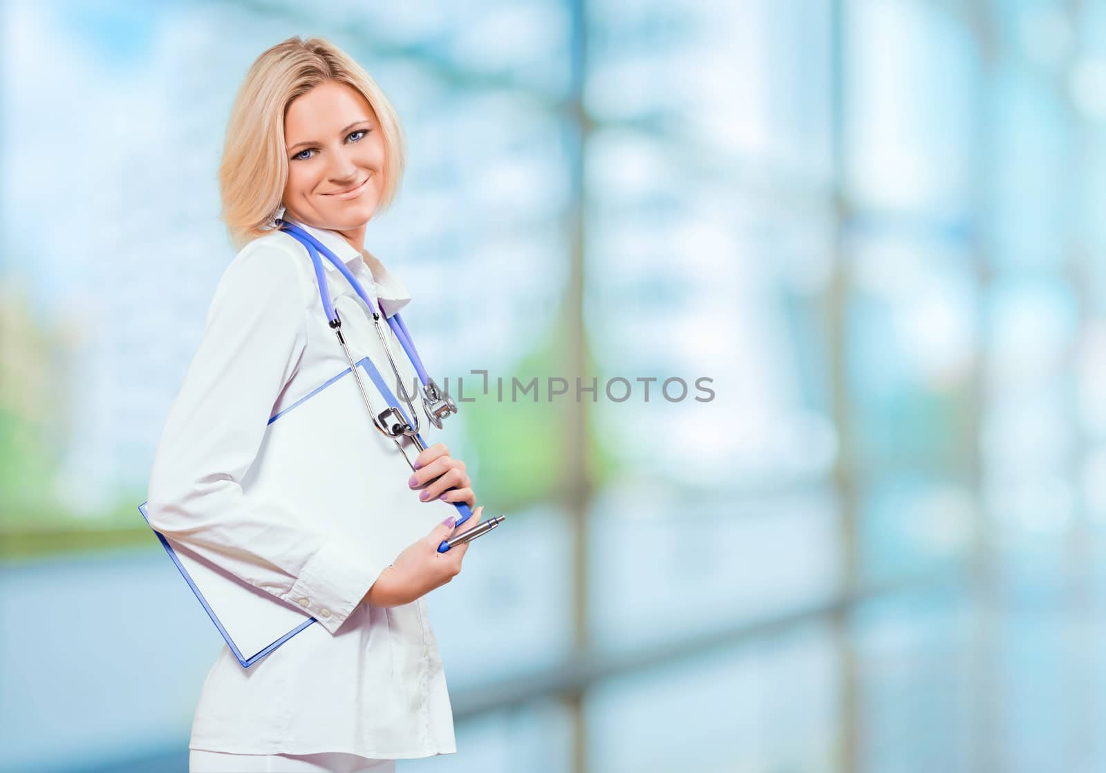 female doctor holding clipboard in office