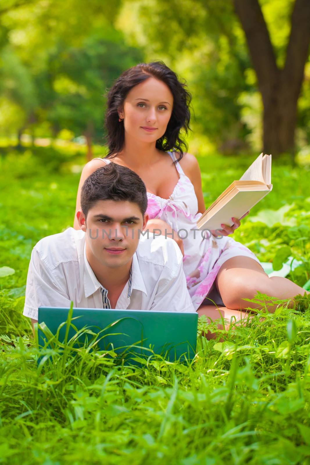 man and woman resting on nature