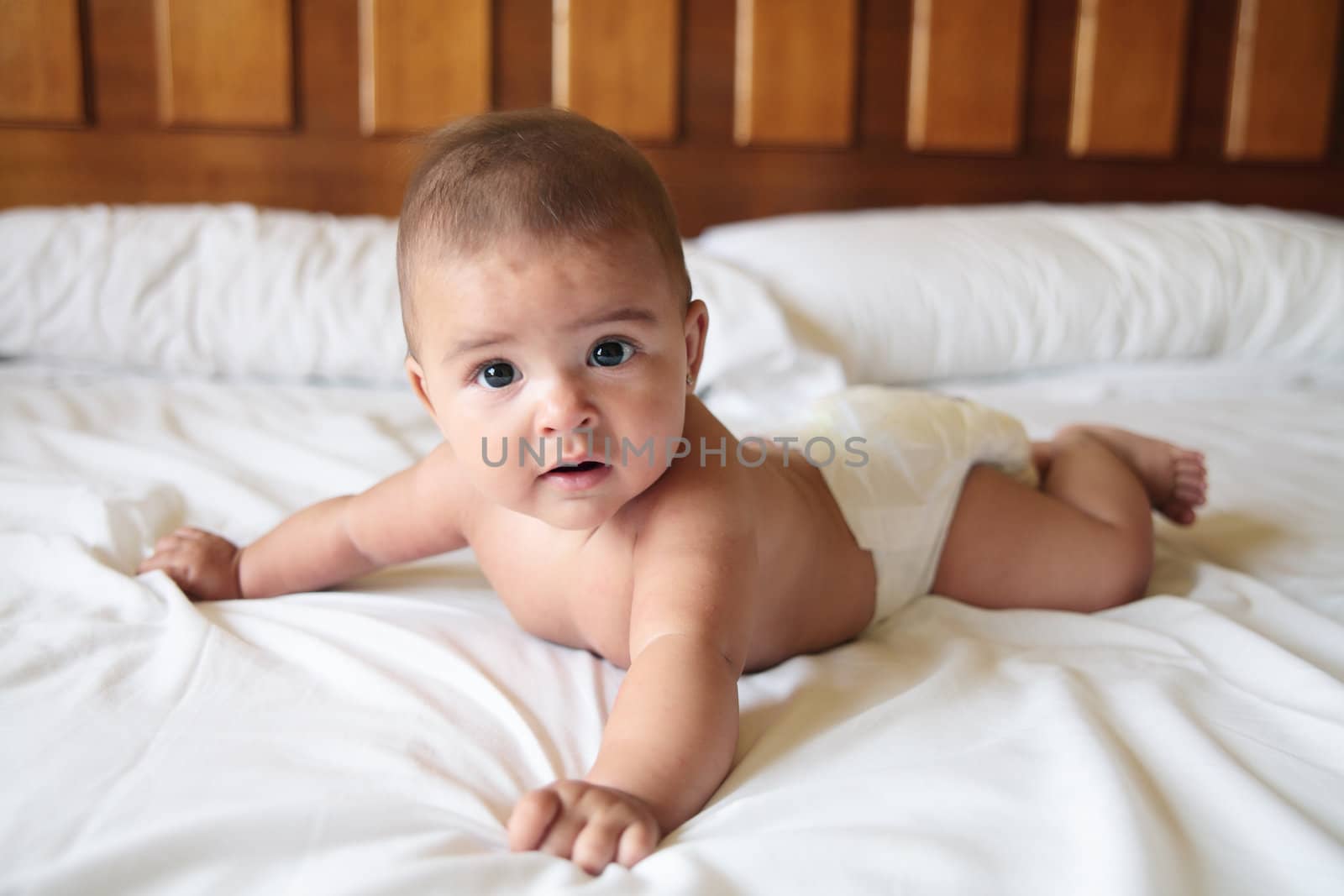 a beautiful caucasian baby on a bed