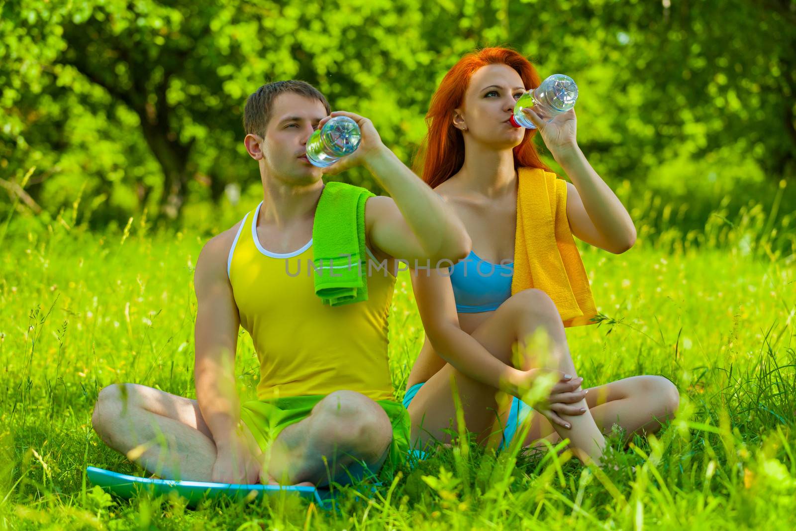 sports couple drinking water by mihalec