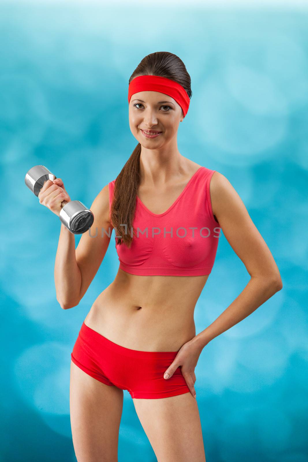 a beautyful sporty girl with dumbbell