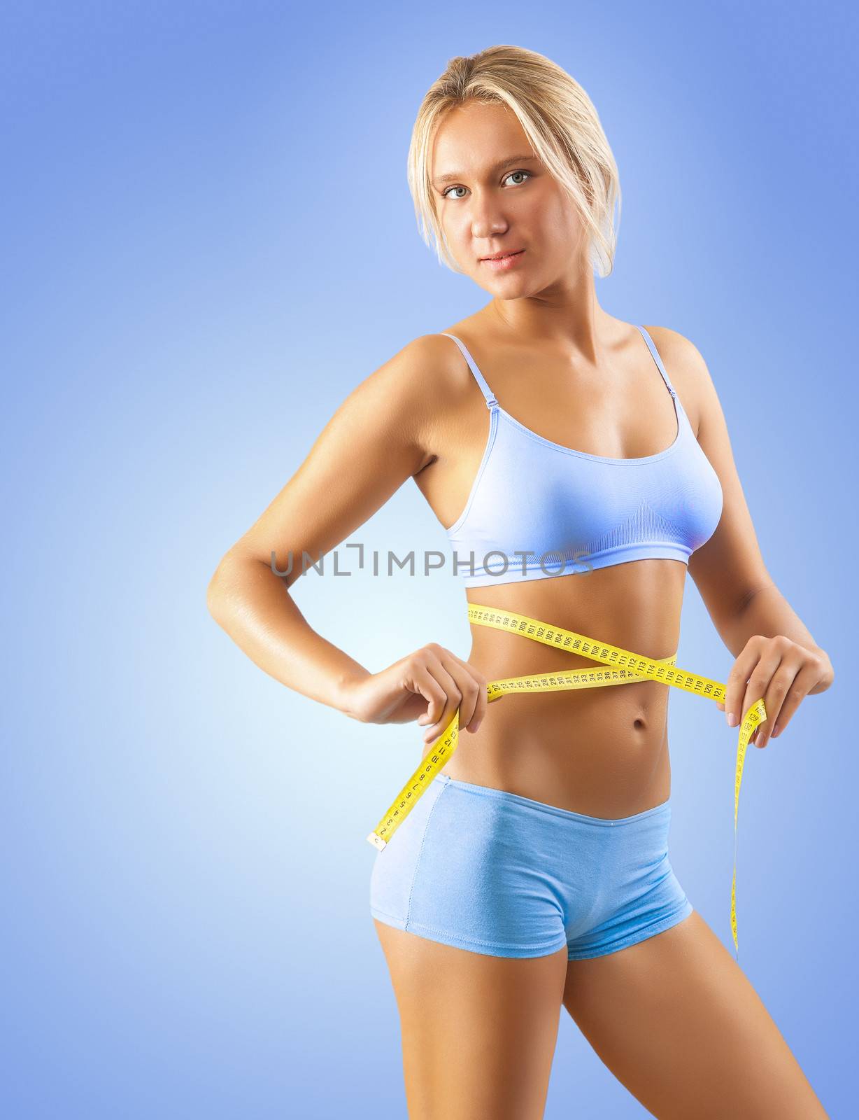 a girl measuring waist