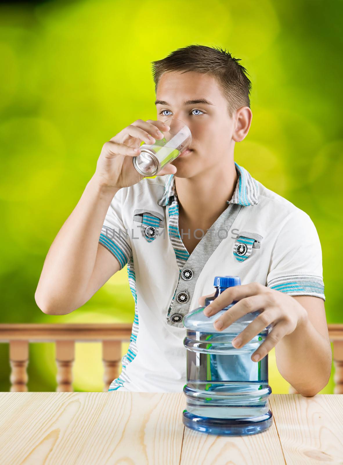 a guy drinking water from glass