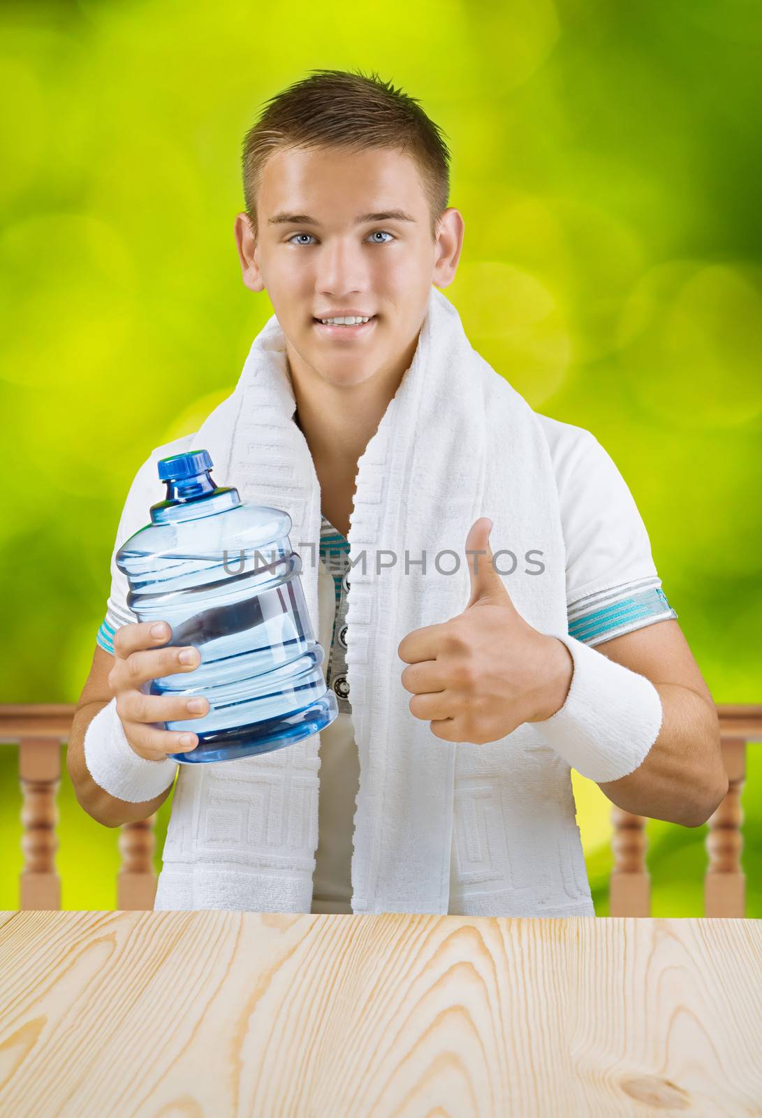 a guy holding big bottle of water by mihalec