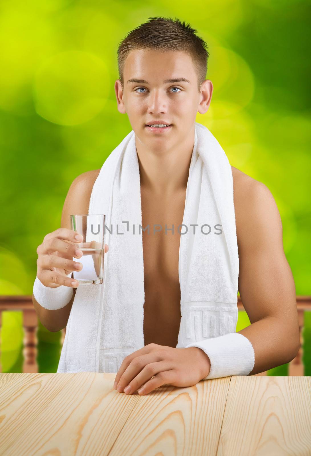 a guy holding glass of water