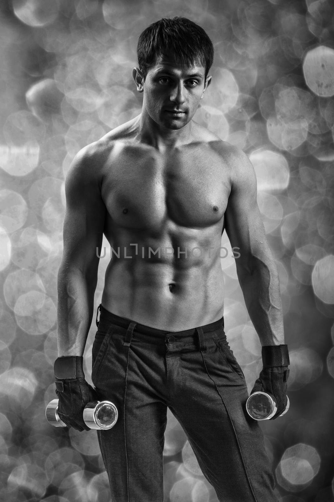 a muscular man on a background of bokeh by mihalec