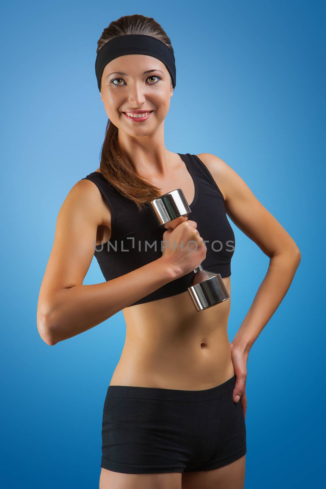 a sports girl posing with dumbbell by mihalec