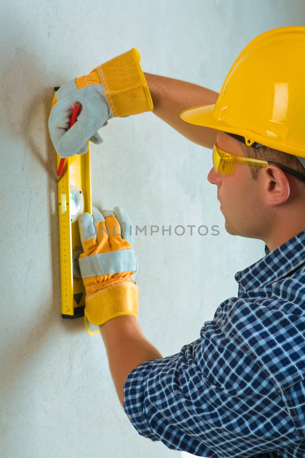 a worker layering on cocrette wall by mihalec