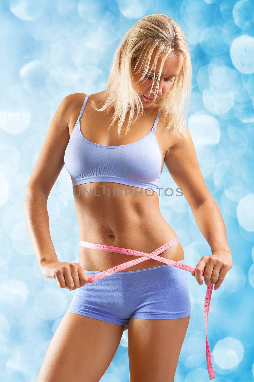 a young girl measuring waist