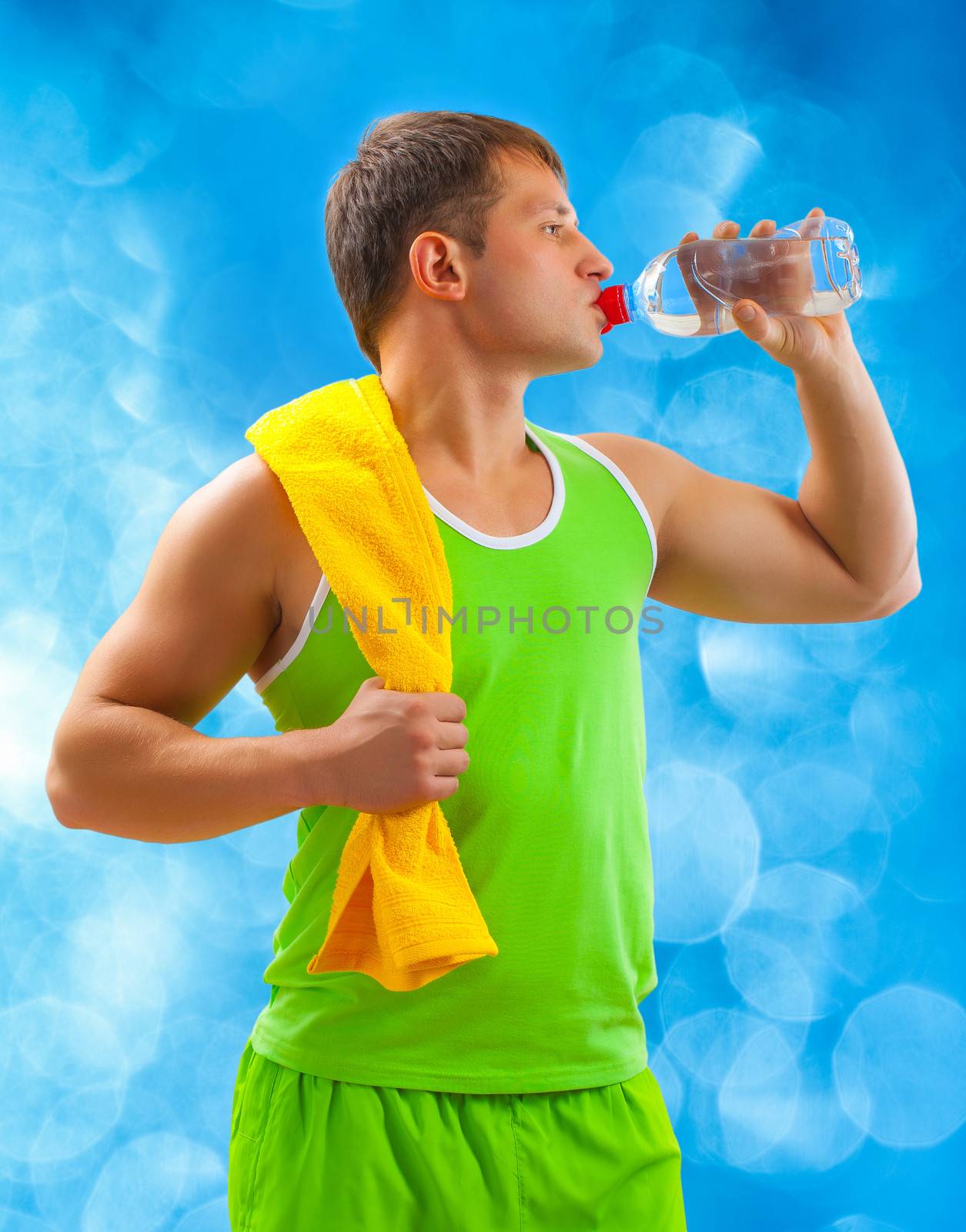 a young sports man drinking water