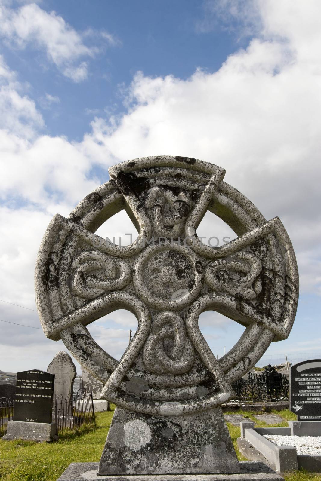 an ancient celtic cross against in Irish cemetary