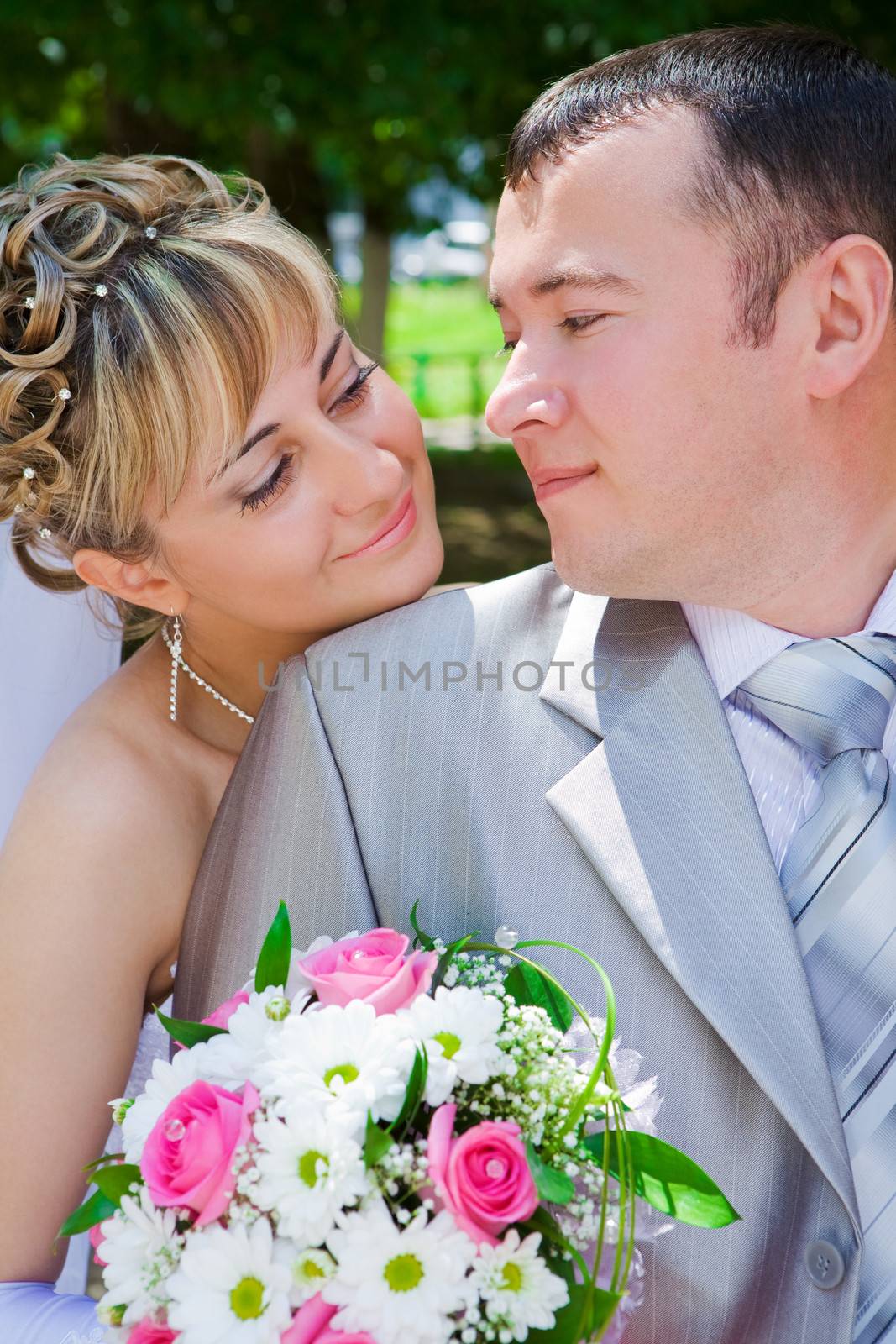 The groom and the bride look against each other by mihalec