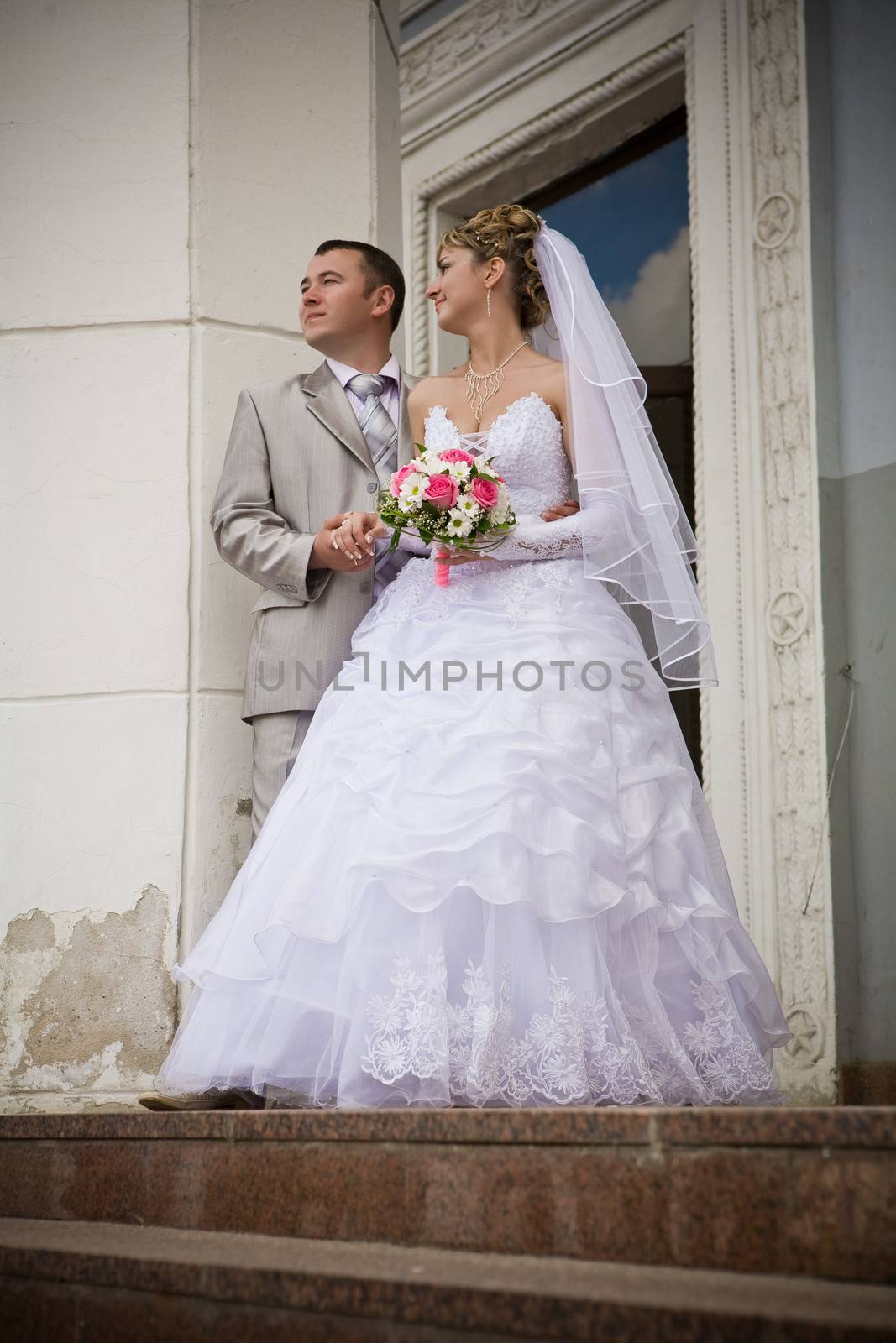 The groom and the bride on a background of the old vintage bilding