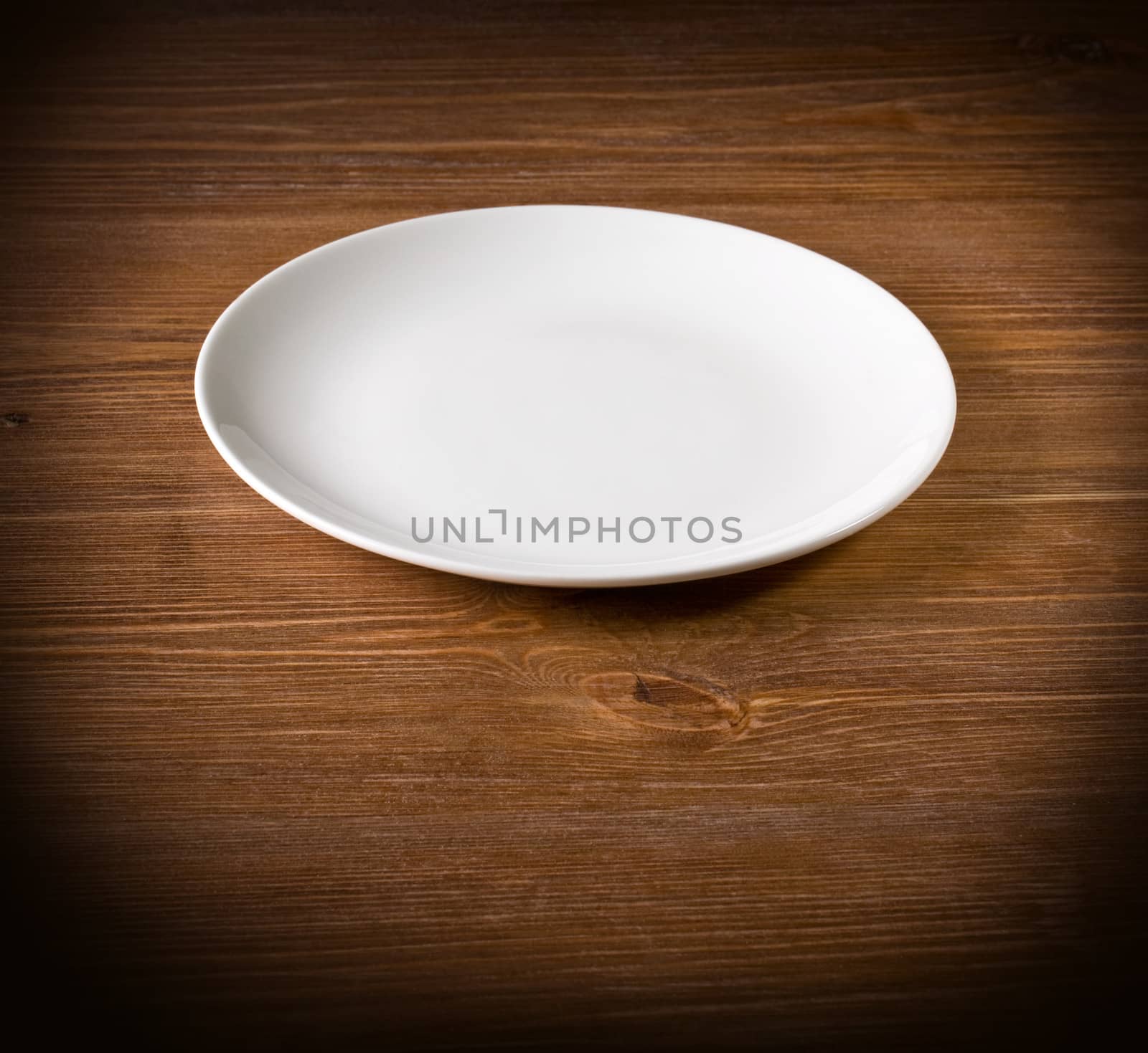 white plate on a wooden background