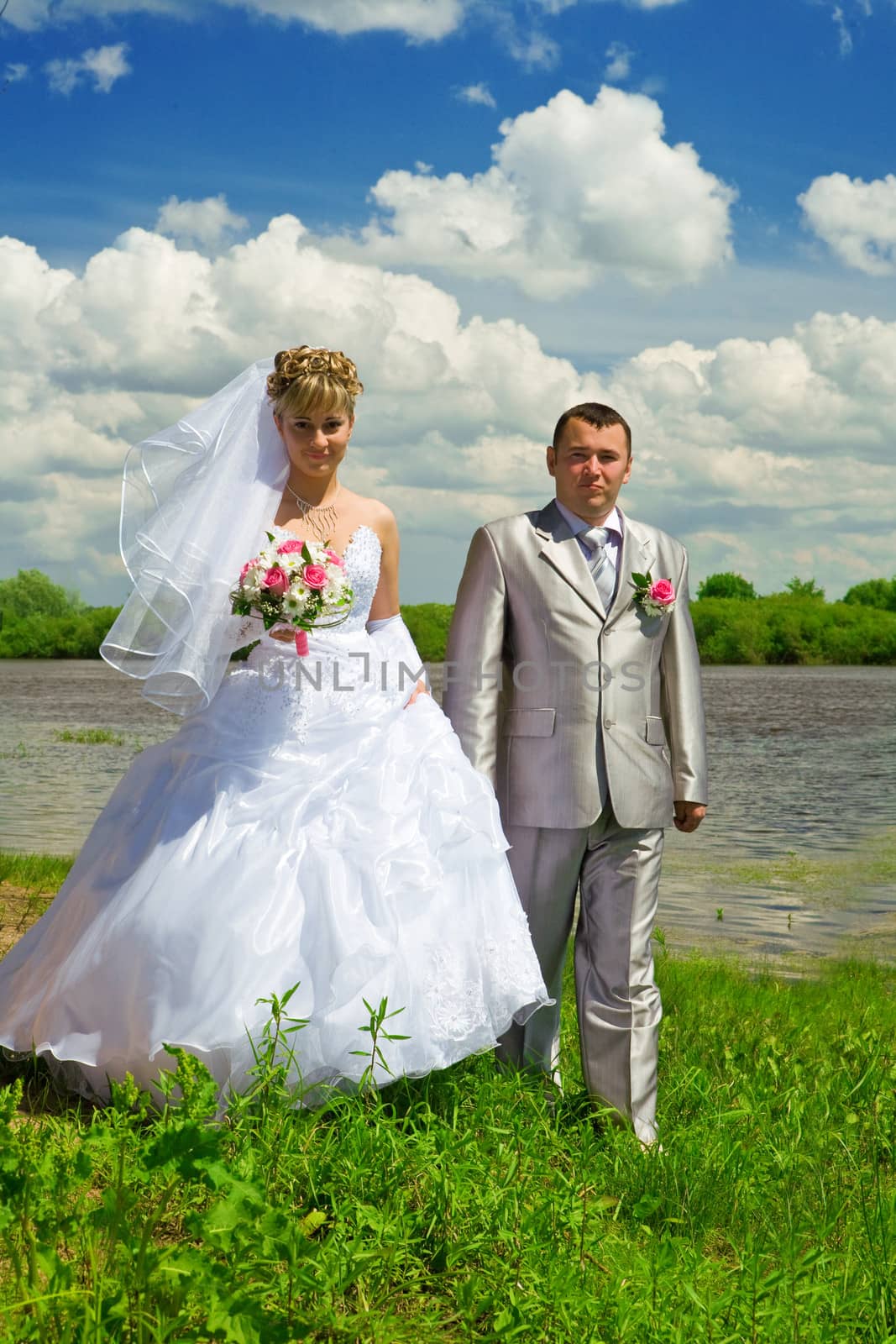 Wedding pair on coast of the river by mihalec