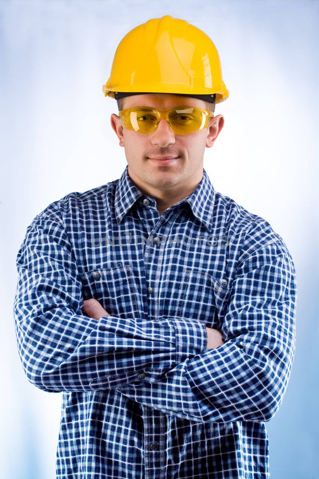worker in a hardhat and yellow goggles by mihalec