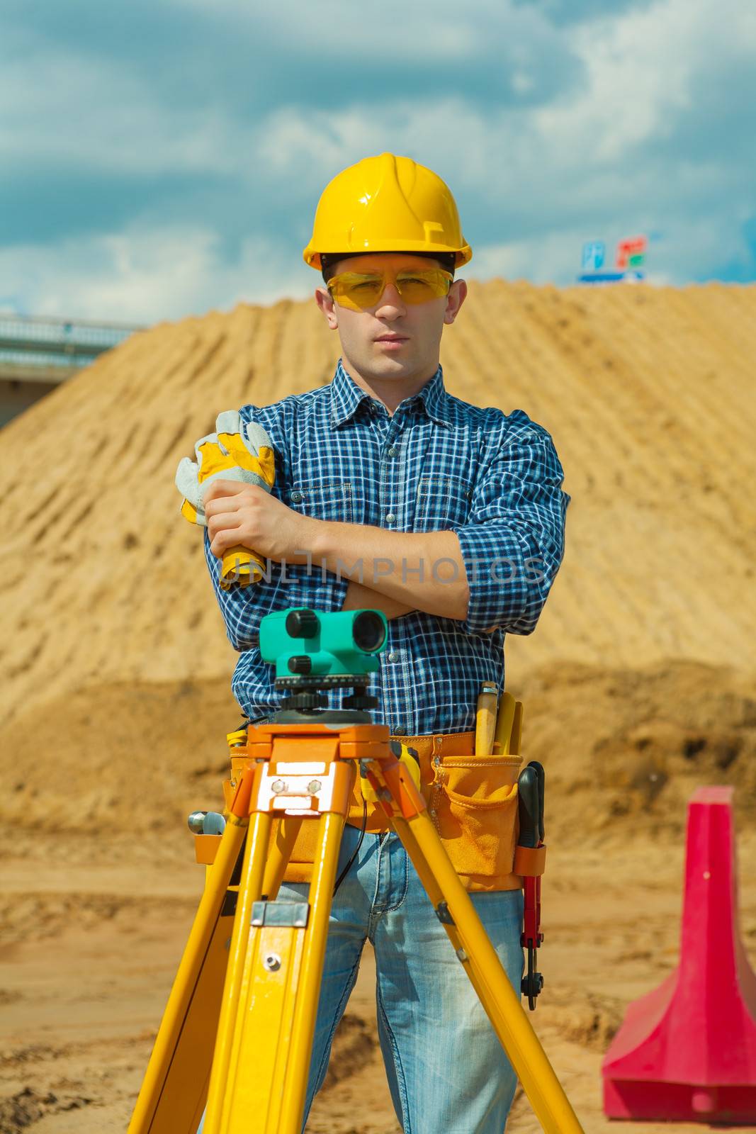 a contractor with theodolite on building place