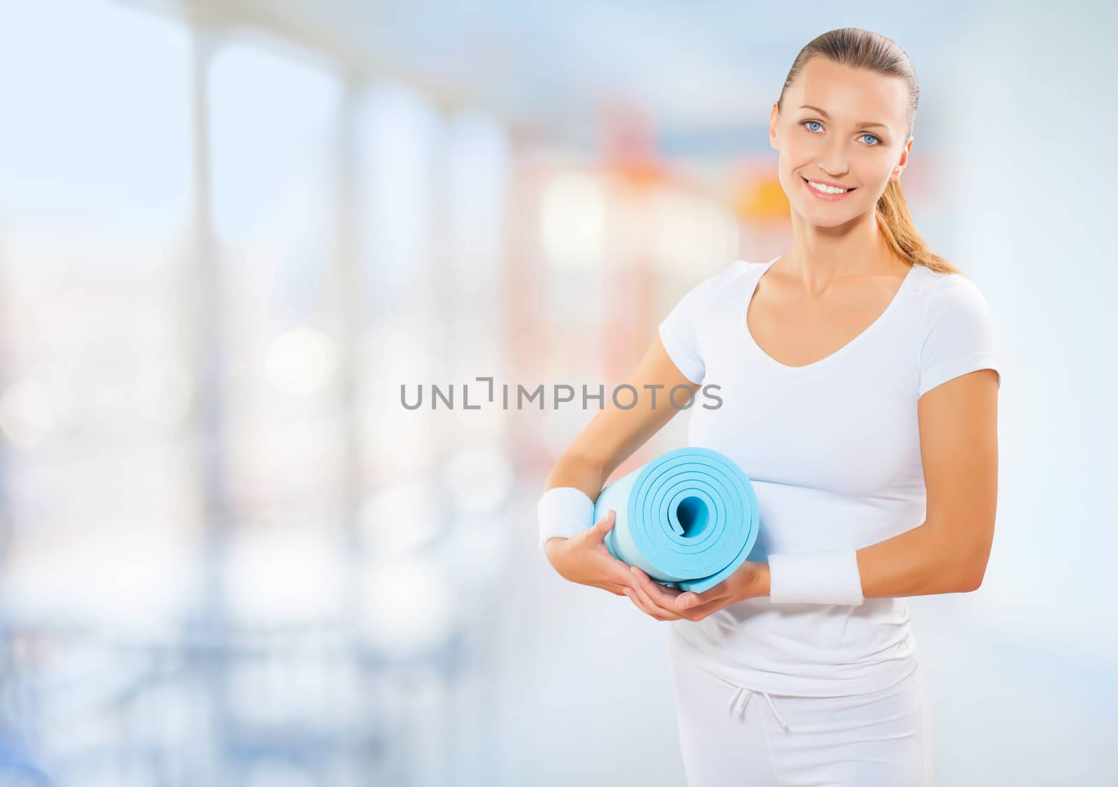 a fit woman with sport mat