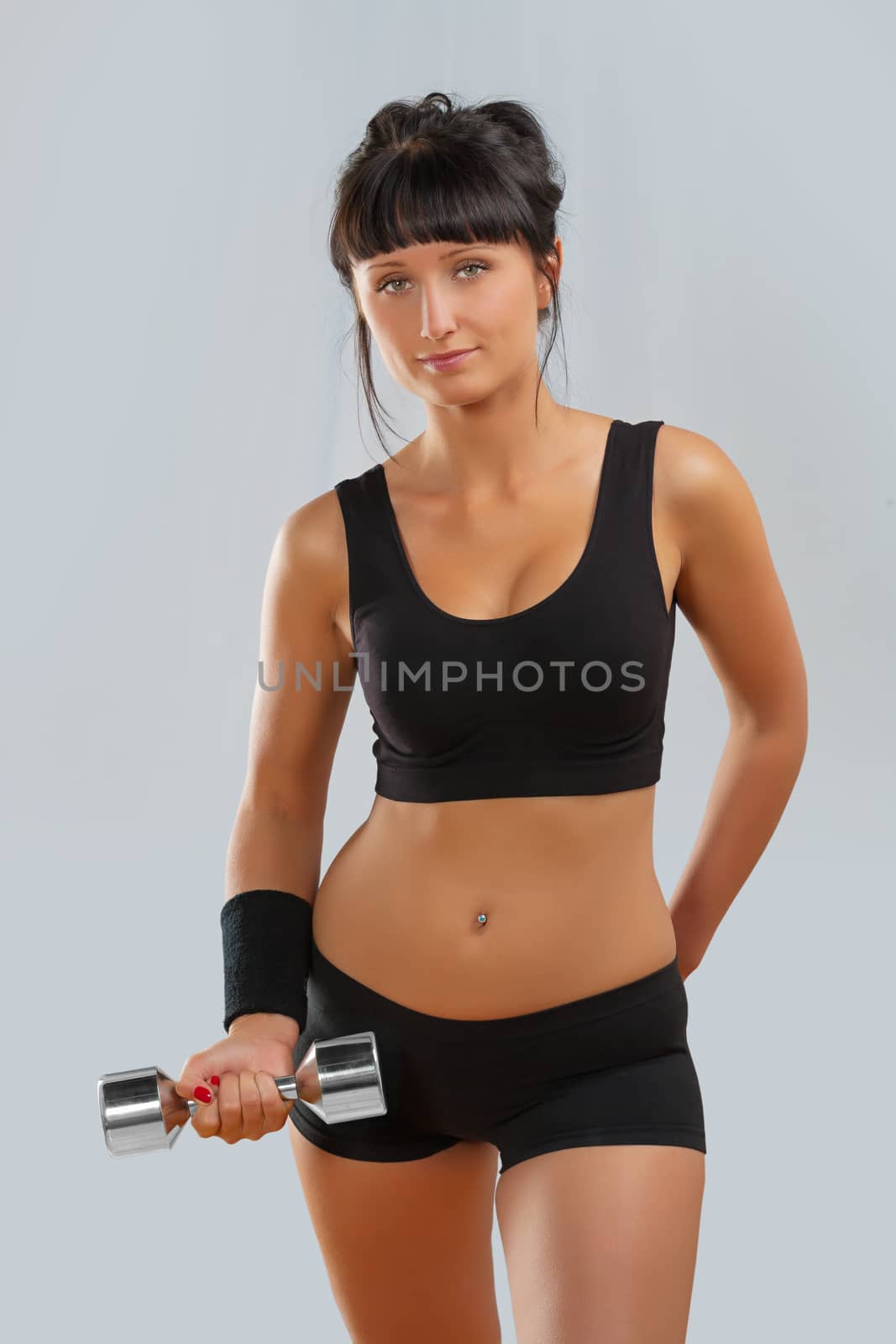 attractive brunette with dumbbell by mihalec