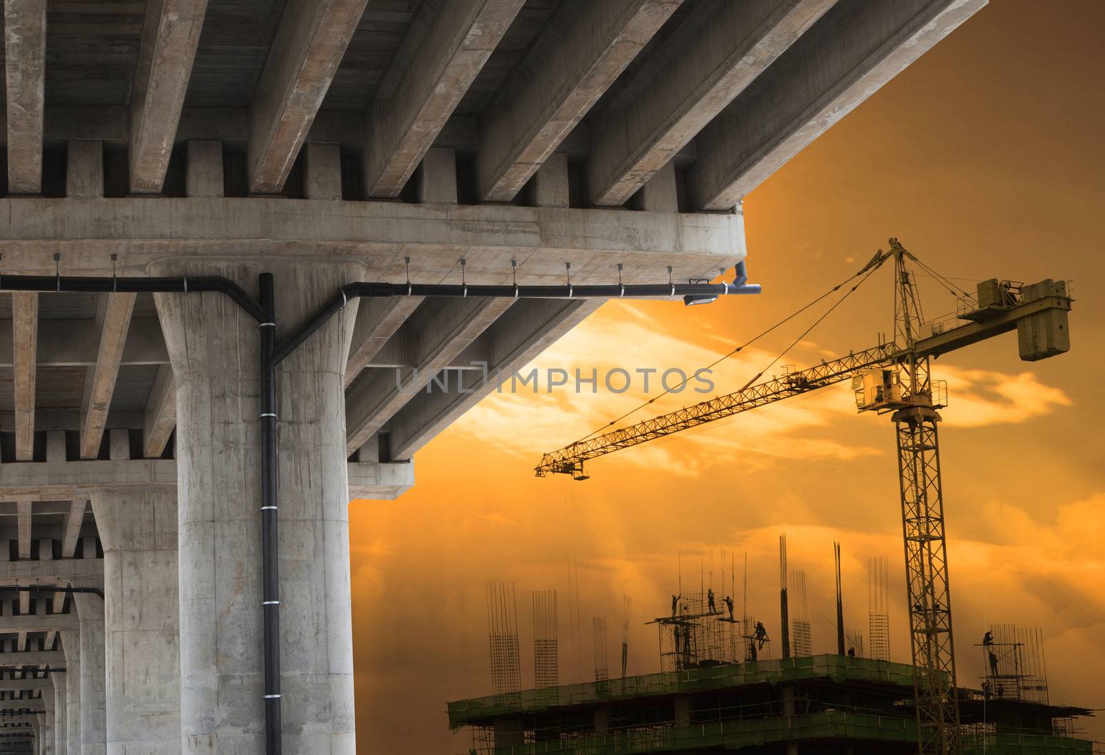 urban development by big crane building construction  with beautiful sky in evening scene