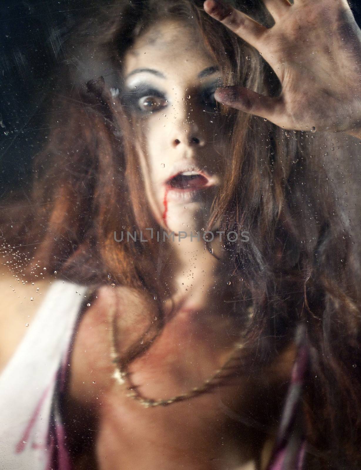 Frightened woman behind the glass by andersonrise