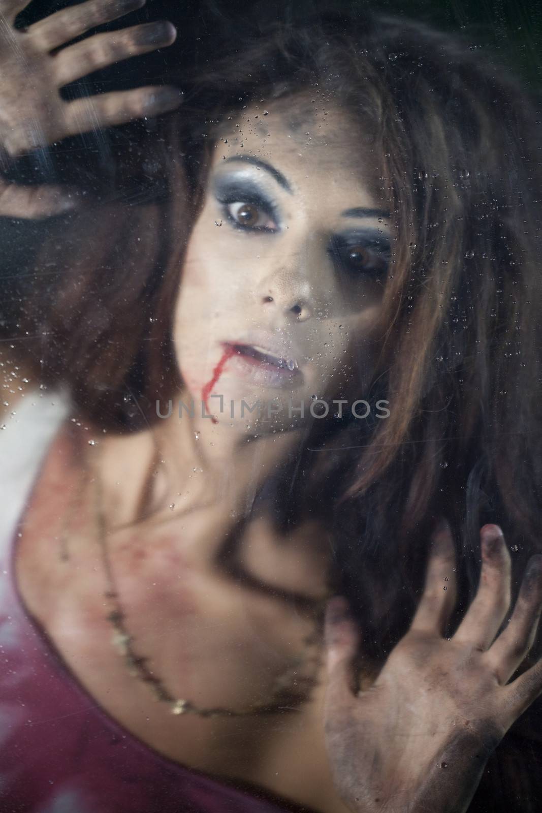 Frightened woman behind the glass by andersonrise