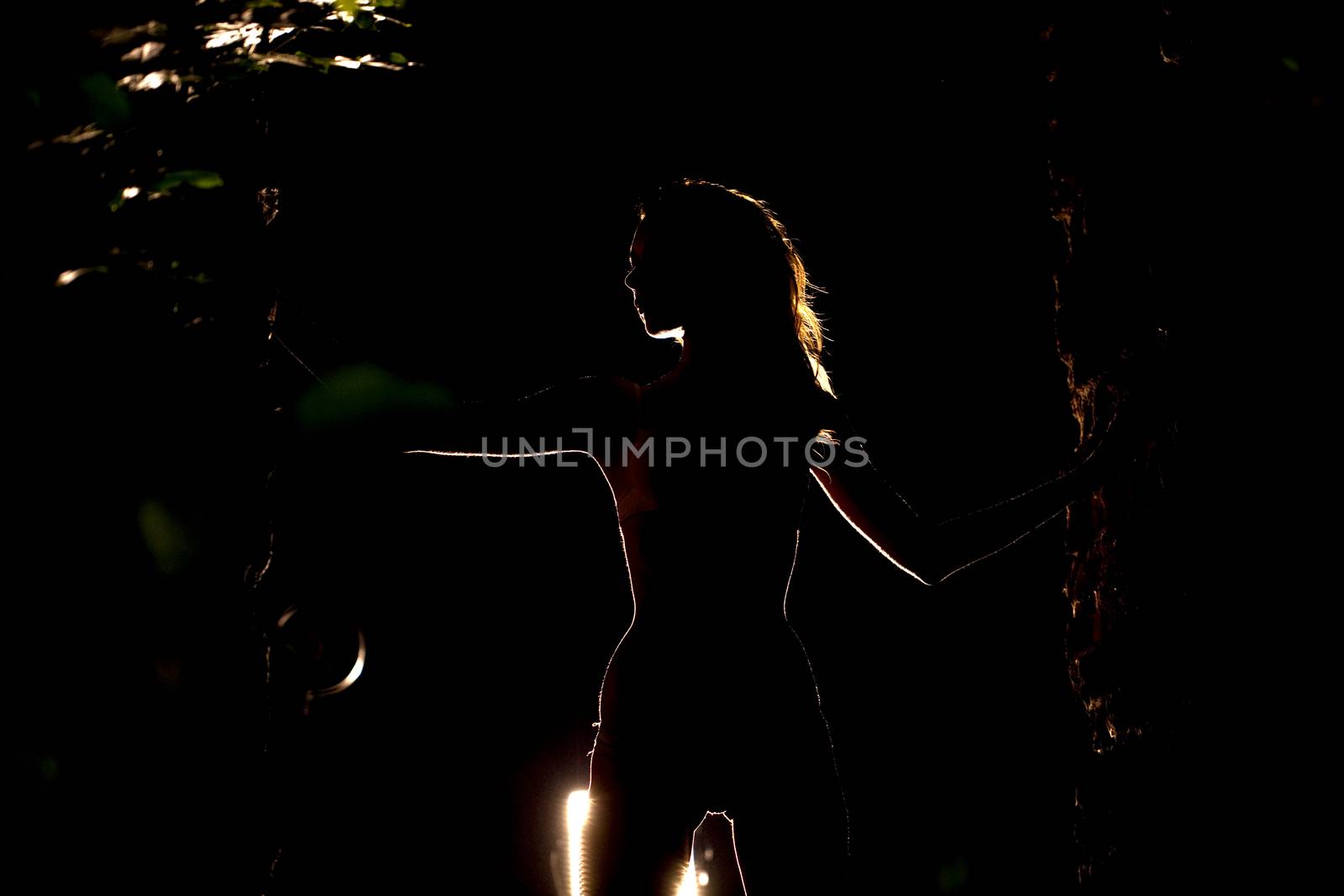 Silhouette of a slender young woman by andersonrise