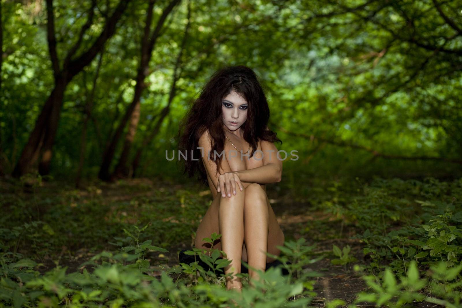 Mysterious naked girl sitting in a dark forest by andersonrise
