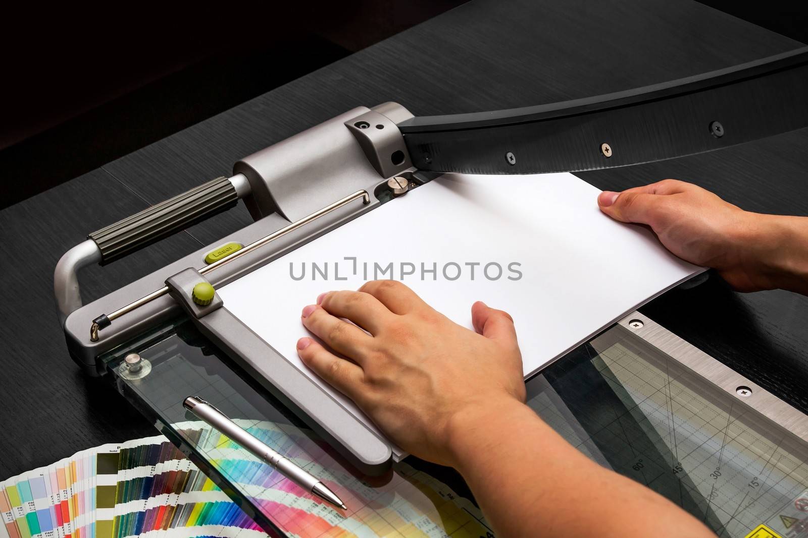 Man working on the guillotine for paper by simpson33