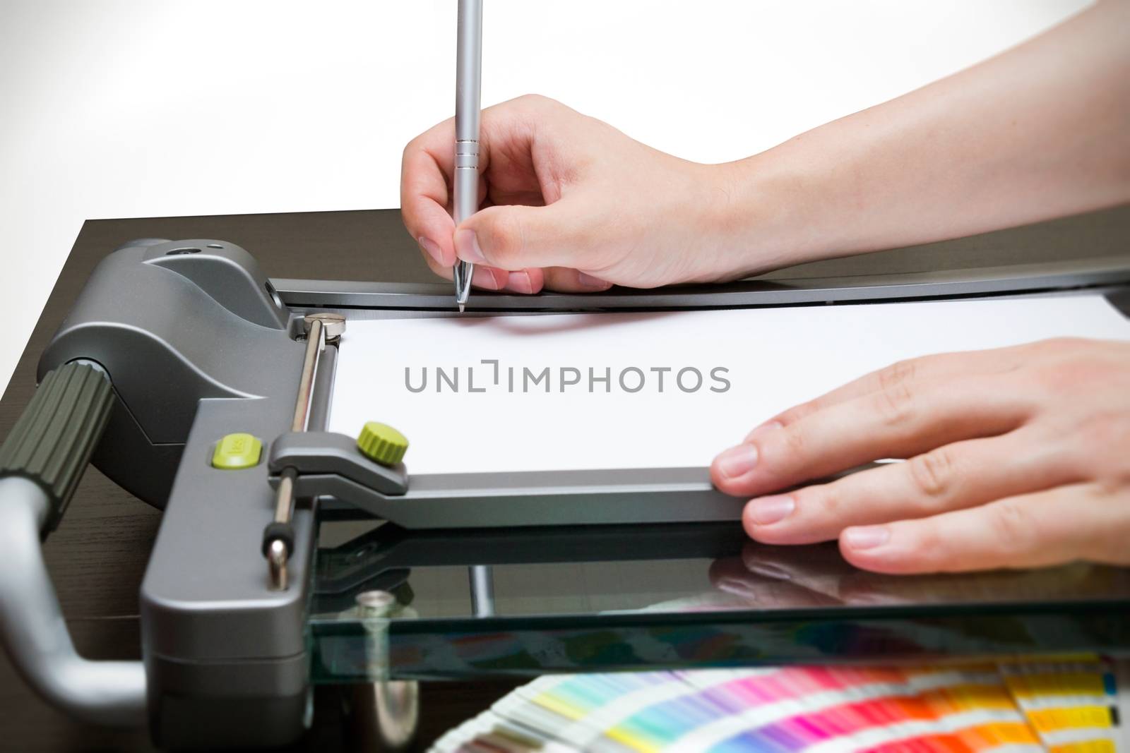 Man working on the guillotine for paper