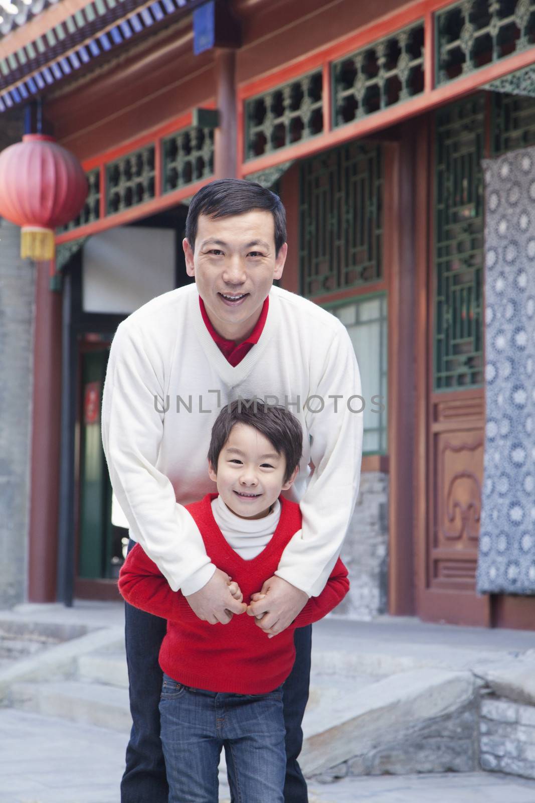 Portrait of father and son by a tradition Chinese building