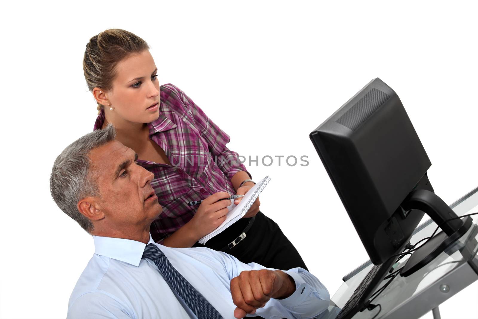 Businessman and his assistant looking at a computer
