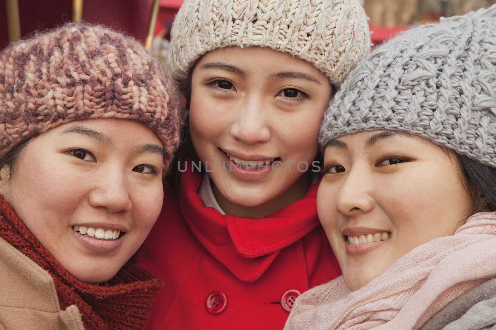 Portrait of three friends outdoors in winter, Beijing